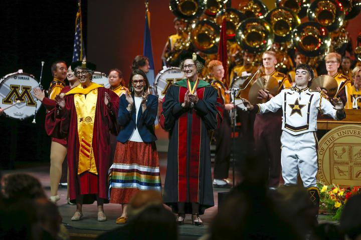 Jamie Mayeron, Peggy Flagan, President Cunningham, and the Marching band