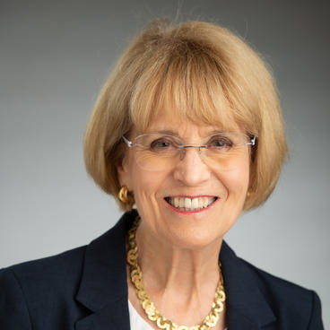 a lady wearing a black coat and glasses